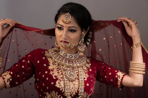 Young Indian woman in bridal wear, jewelry and make-up. Woman with bridal expressions