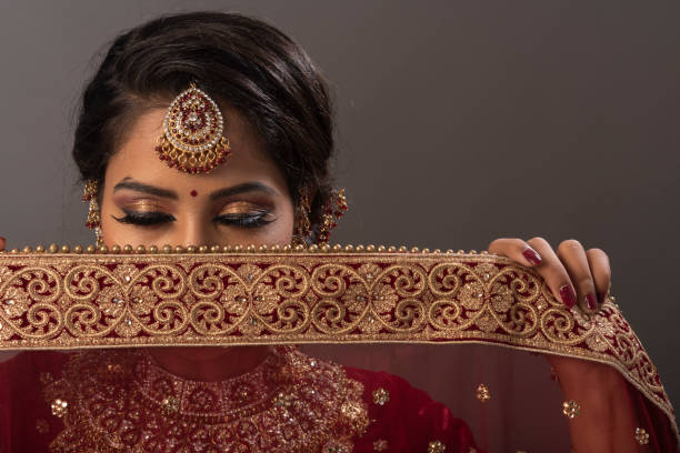 Young Indian woman in bridal wear, jewelry and make-up. Woman with bridal expressions